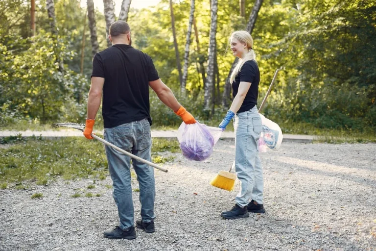 Couple collects garbage in garbage bags